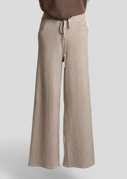 Mannequin wearing a brown sleeveless top and beige wide-leg pants on a light gray background