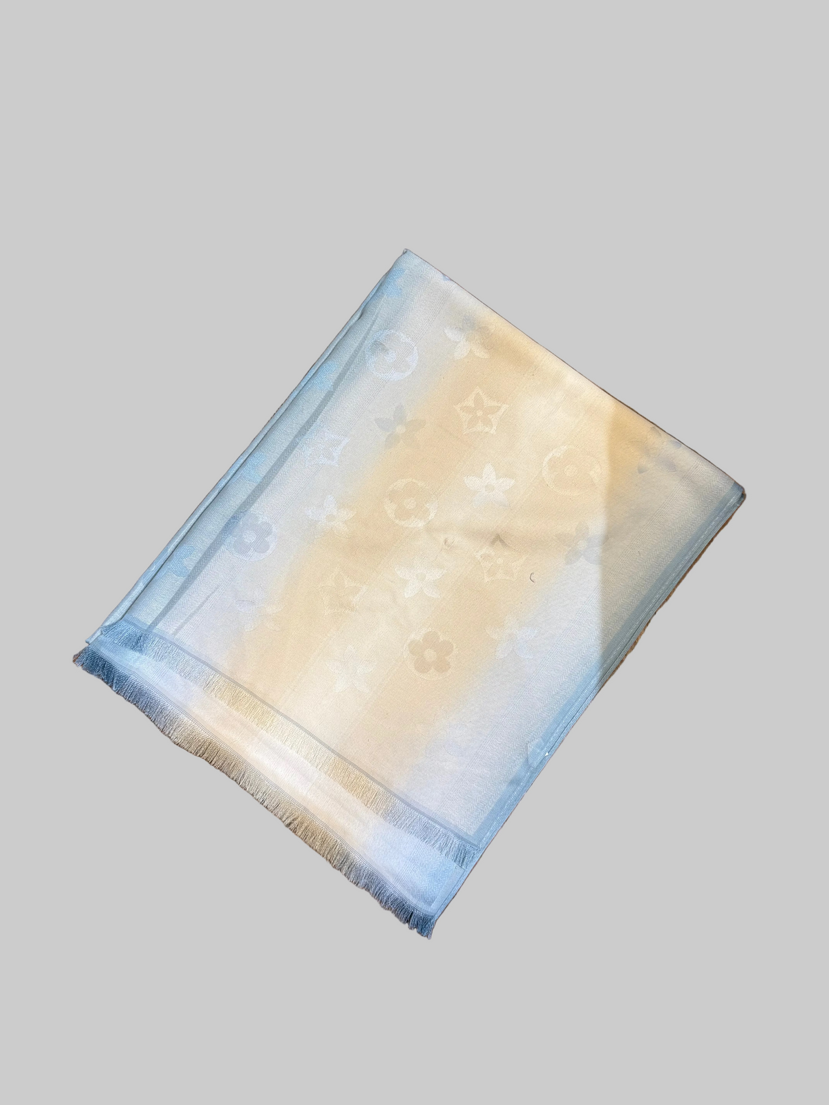 blue and cream scarf on white background