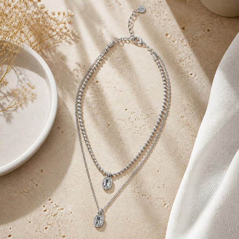 Chandeliers Boutique ny Double Dare You double-strand silver-plated necklace with crystal pendants on stone surface
