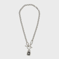 Chandeliers Boutique ny pewter toggle necklace with a chunky silver-tone link chain and dark rectangular pendant.