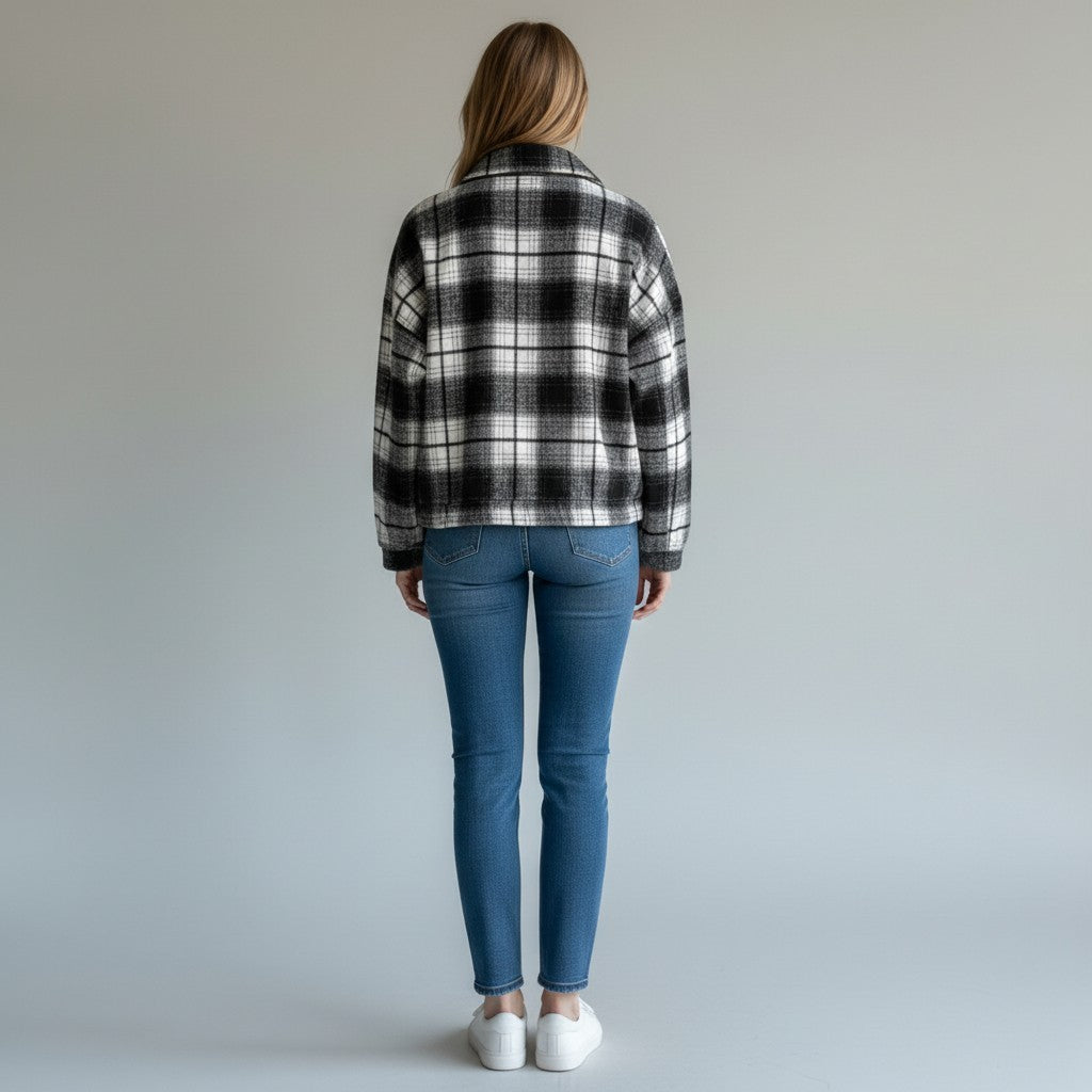 Chandeliers Boutique ny crop flannel jacket in black and white plaid with a collared zip front, worn from the back.