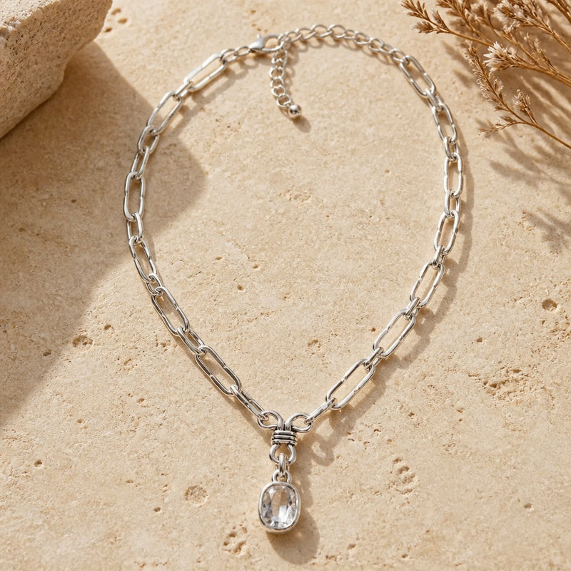 Chandeliers Boutique ny Lucky Day necklace featuring a silver plated chain with a clear crystal pendant on stone.