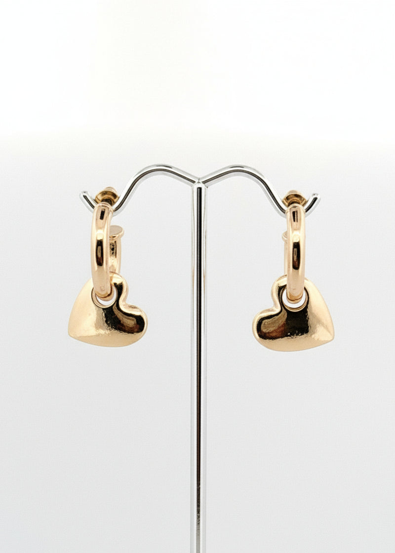 Gold heart-shaped hoop earrings on a white background